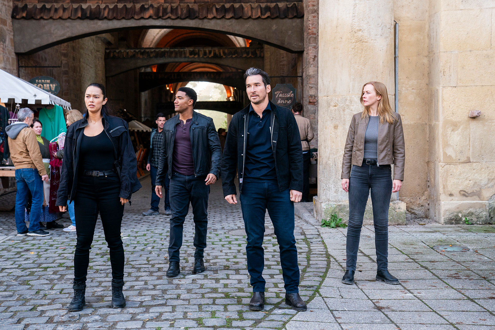 Vinessa Vidotto as Special Agent Cameron Vo, Carter Redwood as Special Agent Andre Raines, Jay Hayden as Agent Tyler Booth, and Eva-Jane Willis as Europol Agent Megan “Smitty” Garretson in FBI: International - Keen as a Bean